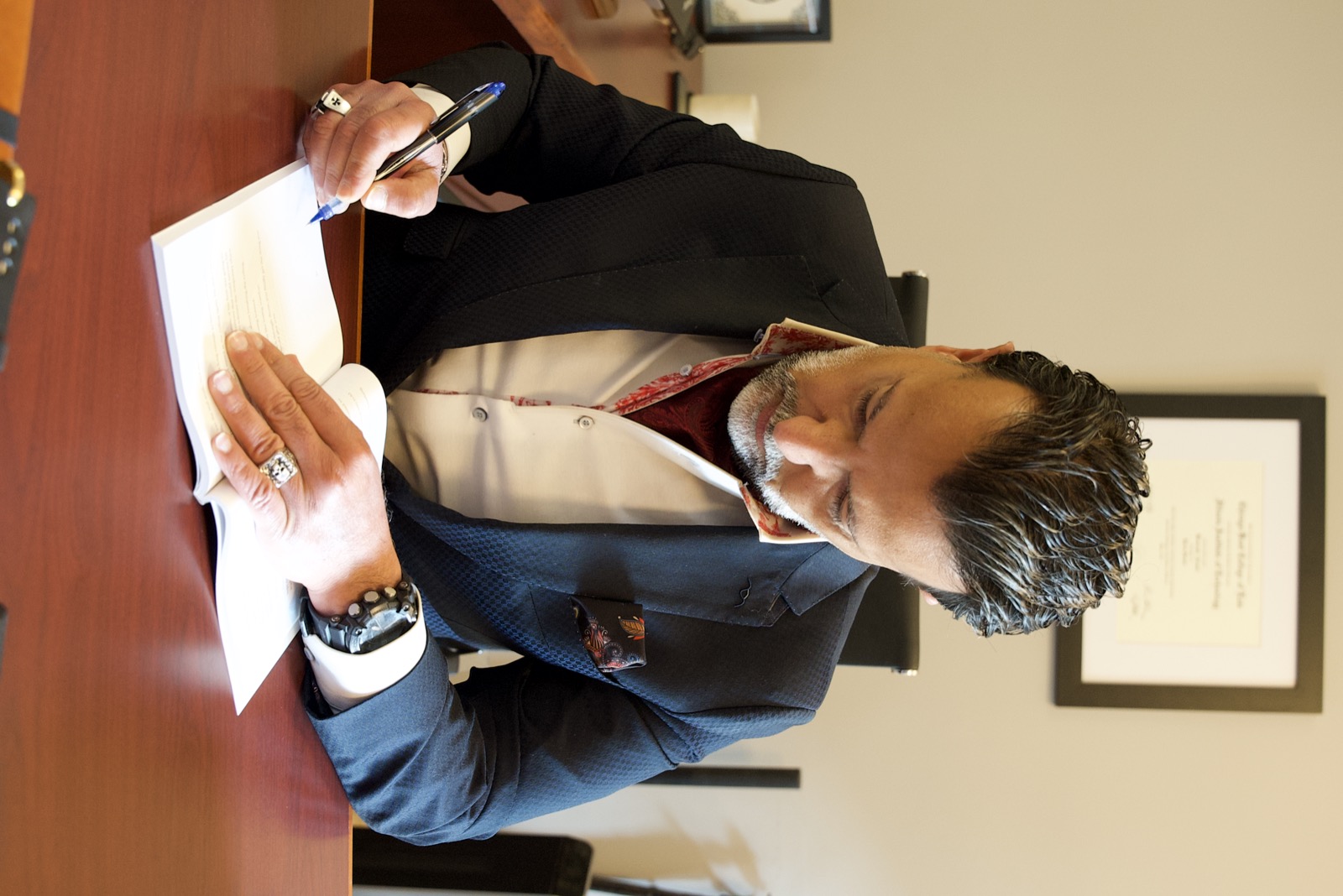 Kourosh Arami reviewing documents at his desk